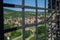 View of a town in green forest behind the old fenced gate of the Devin Castle in Bratislava