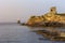 View of the town lighthouse Tourlitis, fortress and the sea Greece, island Andros, Cyclades