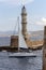 View of the town lighthouse, yacht and the sea