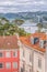 View of traditional classic buildings, with blurred Mondego river and Rainha Santa Isabel Bridge as background in Coimbra,