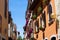 View of traditional colorful croatian buildings with flower pots in the windows, in the old town of Porec also called Parenzo,