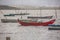 View of traditional fishing boats floating on the edge of the Nazare lagoon, strong wind and rain, in Portugal