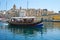 The view of traditional Maltese boat Luzzu in Dockyard bay on th