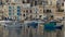 The view on traditional Maltese boats in sunset