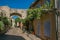 View of traditional Provence houses and arch on a street at sunrise, in ChÃ¢teauneuf-de-Gadagne.