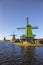 View of Traditional Wooden Dutch Windmills at the Zaan River in Zaanse Schans
