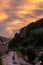 View of traffic down the main street Canillo, Andorra at sunset, street lamps lit and clouds with color in the sky, side of the