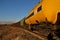 View of the train of cisterns and wagons at sunrise against the blue sky.