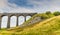 A view of a train exiting the Ribblehead Viaduct, Yorkshire, UK