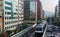 View of a train traveling on elevated rails of Taipei Metro System and making a sharp turn between office towers