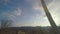 View through train window, sunny blue sky with clouds, trees, hills on horizon