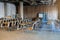 view of a training room/conference hall interior with rows of wood chairs with a small table for each of them