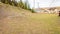 View of a transmission line, houses, trees, and rocks with a clear sky background