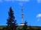 View of transmitter with hotel, restaurant and view on top of mountain, summer hiking in mountains, sunny day, blue sky