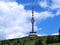 View of transmitter with hotel, restaurant and view on top of mountain, summer hiking in mountains, sunny day, blue sky