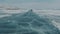 View of the transparent ice in the white cracks of Lake Baikal through the windshield of a car traveling at high speed