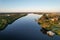 View of trees on the coasts of Manatee River under the blue sky reflected in the water