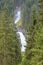 View through the trees of the lower part of the Krimml Waterfalls