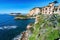 view of Trentaremi bay of Posillipo, a district of Naples, Italy. There is a small empty beach in a cove. The coast overlooks the