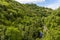 A view through the tress towards the River Wye and the Monsal Trail in Derbyshire, UK