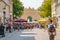 View of Triumph Arc, a city gate in historical downtown of Potsdam, Germany, with many local people and tourists shopping and