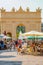 View of Triumph Arc, a city gate in historical downtown of Potsdam, Germany, with many local people and tourists shopping and