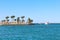 View of tropical island palm trees and promenade ship on sea. Paradise island