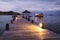 View of tropical island pier and yacht in twilight