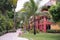 View of a tropical resort with palm trees, walk path and colorful bungalows