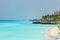 View of tropical tranquil ocean background with fragment of white sand beach