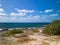 View of a tropical white sand beach surrounded by crystal clear water , North Coast of Cayman Brac