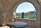 A view trough a stone arch window