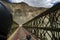 A view of a Truss bridge on the way to Hunder region of Ladakh with Himalayan ranges in the background.