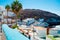 View of Tufia beach an authentic small spanish fishers town on the sea with white and blue houses and palm trees and blue sky