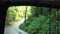 View from a Tuk-tuk car with an open van in Thailand on an empty road in the jungle with steep slides and slopes on Koh