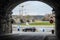 View through the tunnel at the Münzgasse in Dresden. A fast car drives past the Elbe on the terraced shore. Dresden cityscape