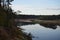 The view of the turn the forest river with reflection of pines.