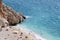 View of the turquoise beach. Beautiful Kaputas Beach Turkey with people resting under the sun and in the sea