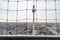 View of TV tower Fernsehturm through mesh fencing