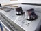 View of two control knobs on a glass stove top in a clean kitchen with wooden counter tops