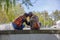 View of two girlfriends girls sitting on a wall and looking at the landscape hand in hand and lovingly