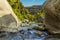 A view between two large volcanic boulders of the course of  the Alcantara river near Taormina, Sicily