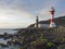 View of two lighthouses, old stone and white-red striped with volcanic rock field at Fuencaliente, La Palma, Canary