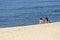 View of two women, alone on the beach, enjoying sunbathing on the beach of Leca da