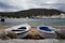 View of two wooden boats on the shore near the famous statue of Salvador Dali Cadaques in Spain