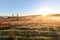 View of typical Alentejo landscape with Portuguese village in morning fog an rising sun at the Rota Vicentina hiking trail near