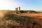 View of typical Alentejo landscape with Portuguese village in morning fog an rising sun at the Rota Vicentina hiking trail near