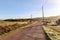 View of typical Alentejo landscape with Portuguese village in morning fog an rising sun at the Rota Vicentina hiking trail near