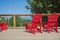 View of typical canadian red muskoka chairs on a wood deck