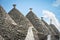 View of the typical conic roof of trullo buildings. Alberobello,  Puglia. Italy